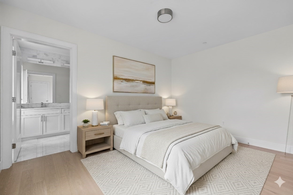 301 Border Street, Unit PH3 Boston, MA 02128 - Photo 2 of 17 a bedroom with a bed and a painting on the wall