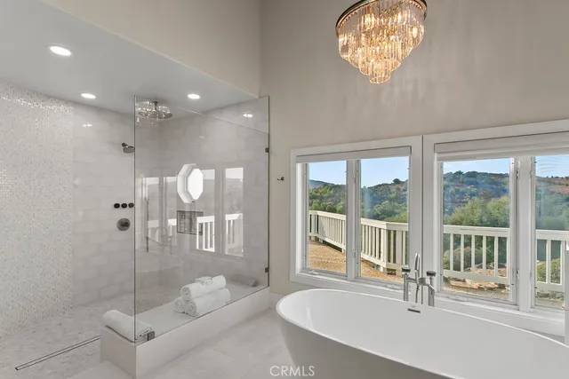 a view of a patio with couches and table and chairs with wooden floor and fence