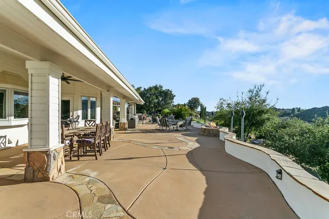 a view of a patio with couches chairs and a potted plant