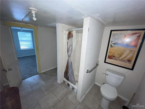 a bathroom with a toilet sink and shower