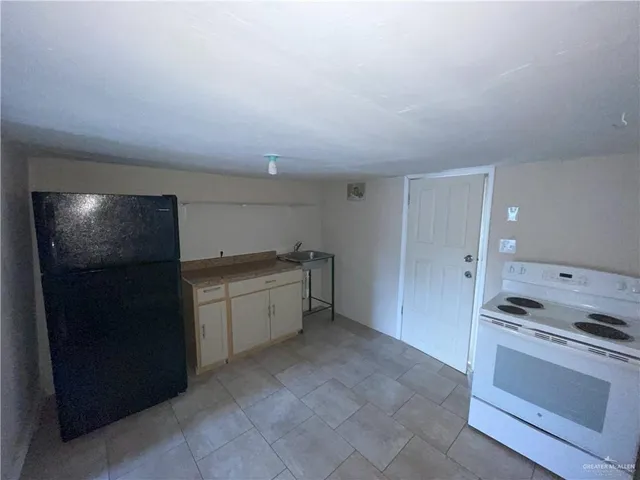 a kitchen with granite countertop a cabinets and steel stainless steel appliances