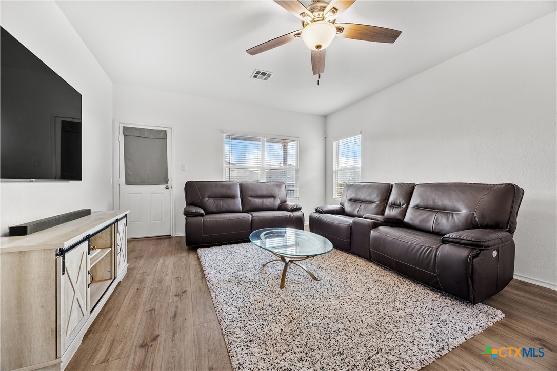 141 Rowdy Yates Way Jarrell, TX 76537 - Photo 11 of 32 a living room with furniture and a flat screen tv
