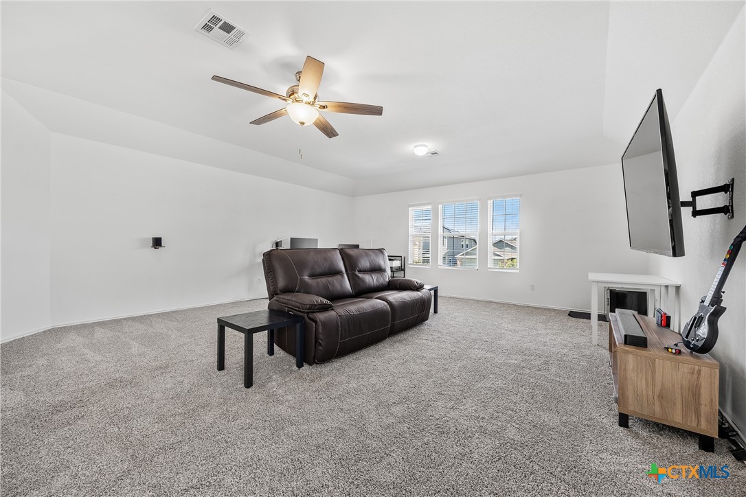141 Rowdy Yates Way Jarrell, TX 76537 - Photo 15 of 32 a living room with furniture and a window