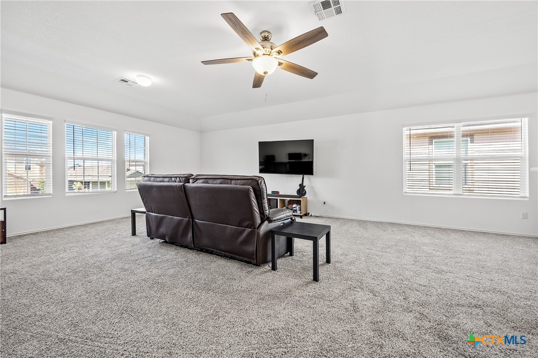 141 Rowdy Yates Way Jarrell, TX 76537 - Photo 16 of 32 a living room with furniture and a flat screen tv