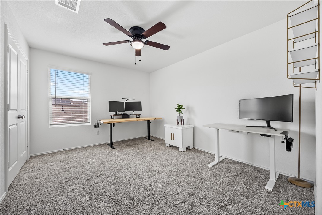141 Rowdy Yates Way Jarrell, TX 76537 - Photo 17 of 32 a living room with furniture and a flat screen tv