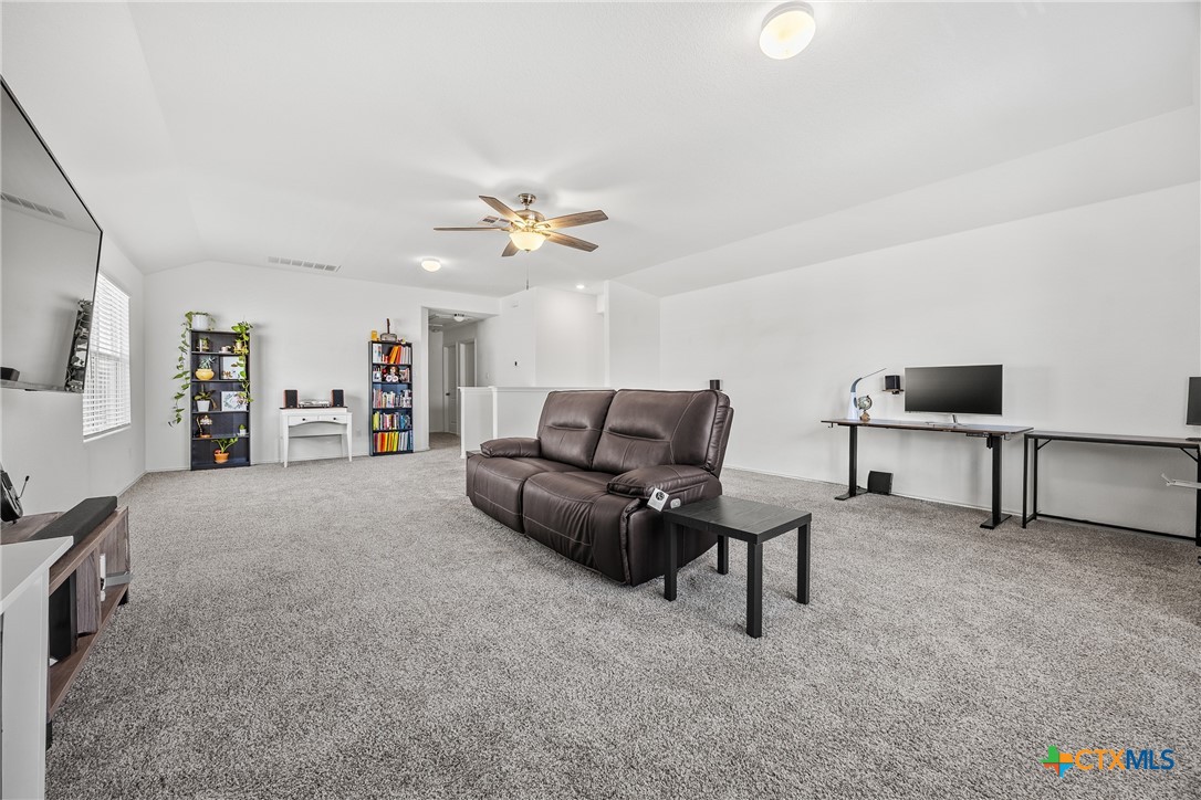 141 Rowdy Yates Way Jarrell, TX 76537 - Photo 21 of 32 a living room with furniture and a flat screen tv