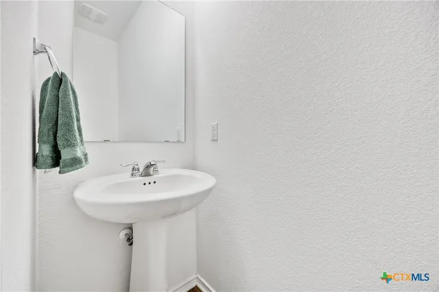 a bathroom with a sink a mirror and vanity