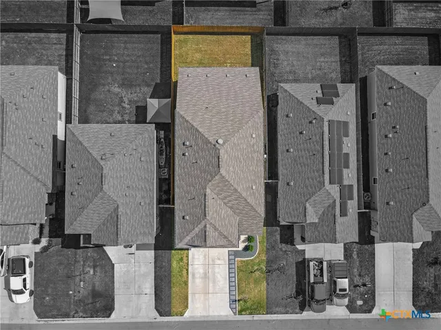 an aerial view of residential houses with outdoor space