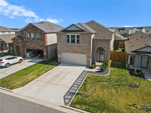 a front view of a house with a yard