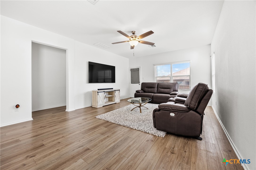 141 Rowdy Yates Way Jarrell, TX 76537 - Photo 9 of 32 a living room with furniture and a flat screen tv