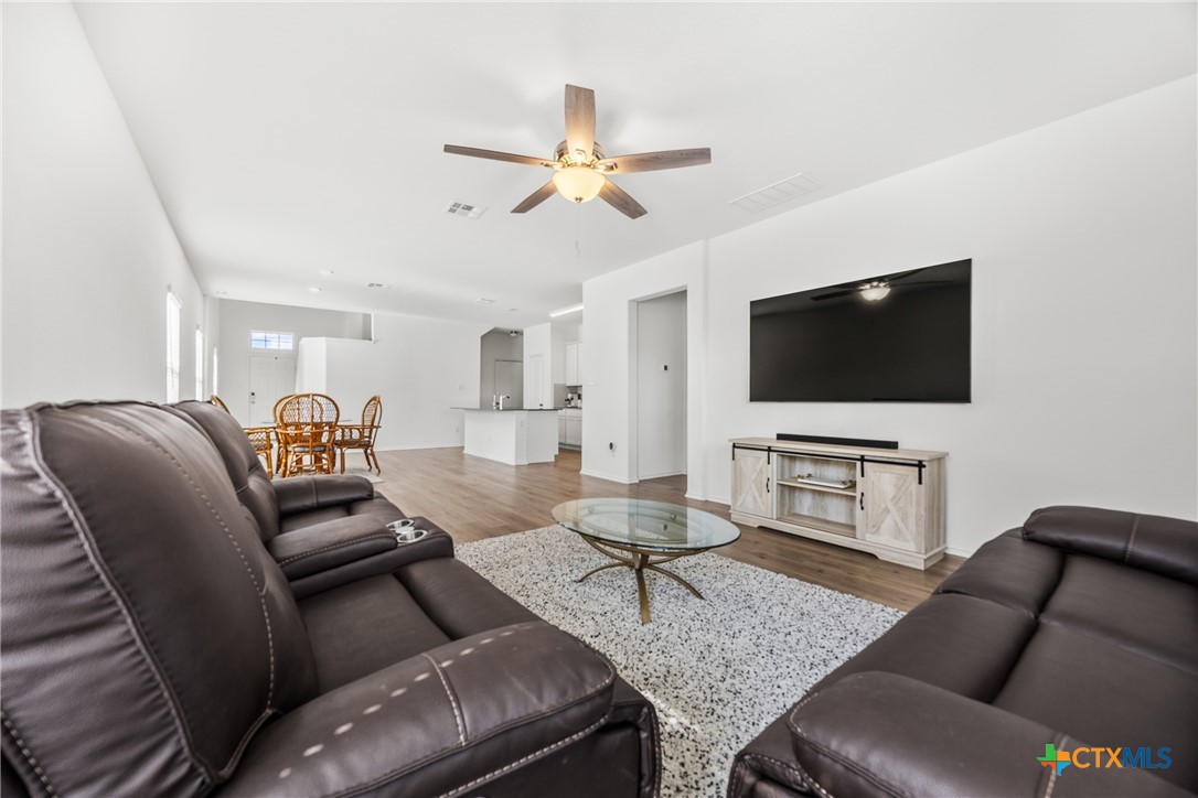 141 Rowdy Yates Way Jarrell, TX 76537 - Photo 10 of 32 a living room with furniture and a flat screen tv