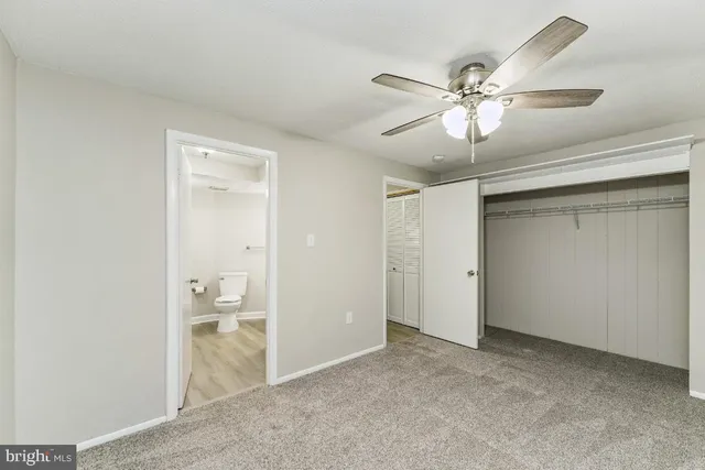 a bathroom with a sink vanity granite toilet and a mirror