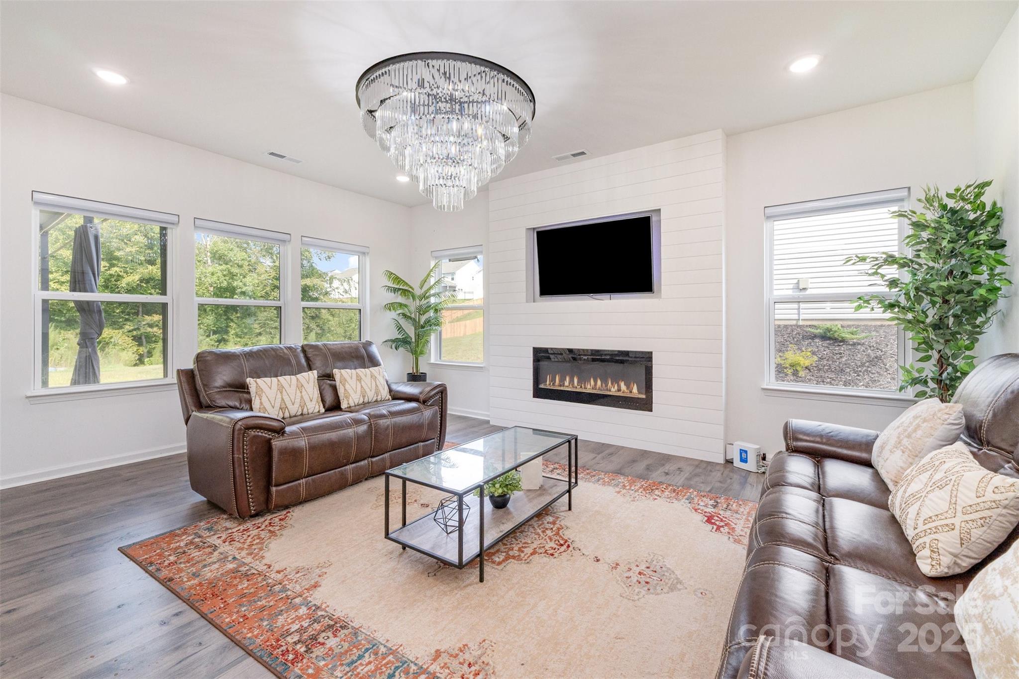 3127 Pinehills Wy. Mount Holly, NC 28120 - Photo 11 of 35 a living room with furniture a chandelier and a flat screen tv