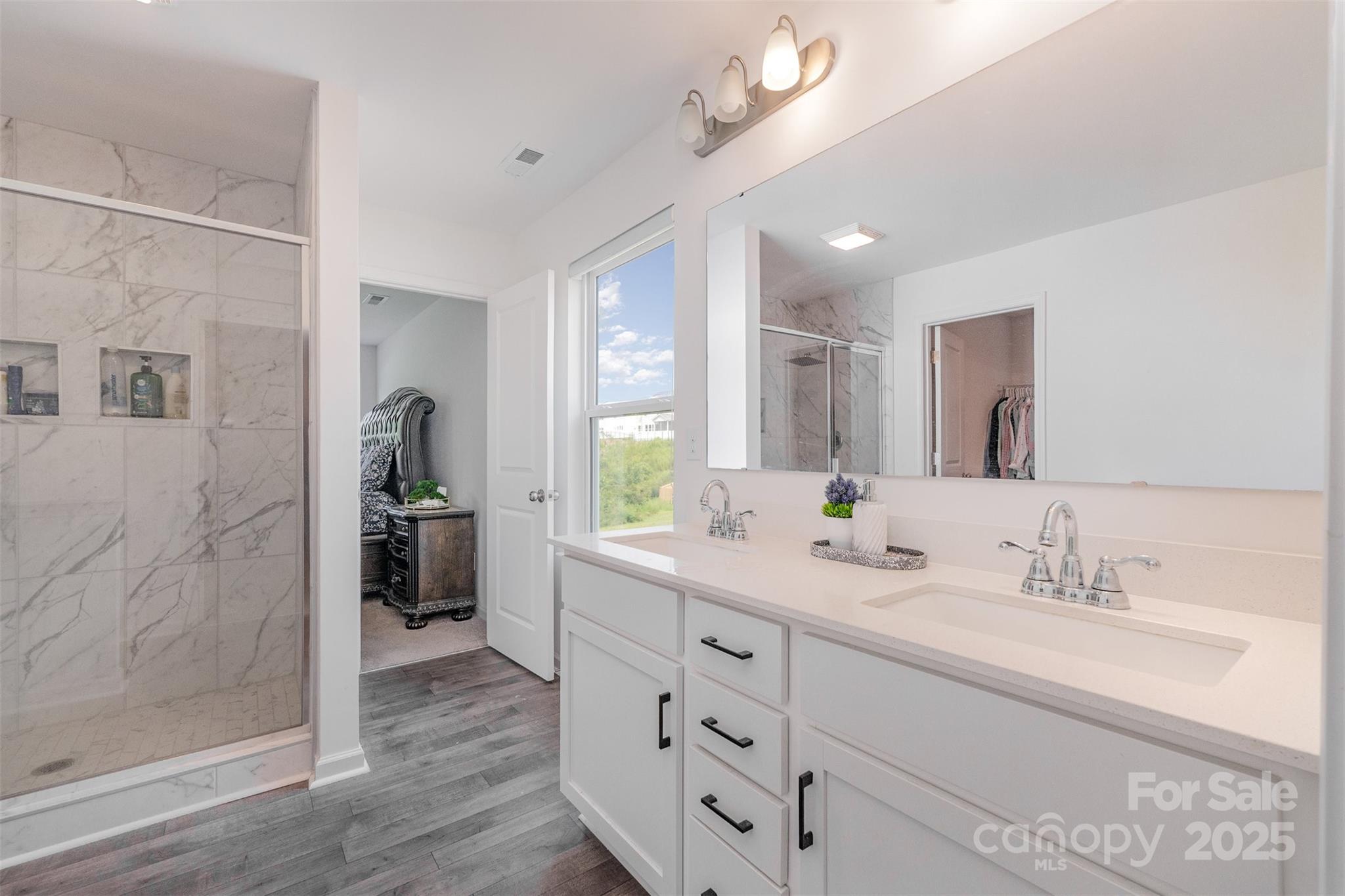 3127 Pinehills Wy. Mount Holly, NC 28120 - Photo 23 of 35 a bathroom with a double vanity sink mirror and shower