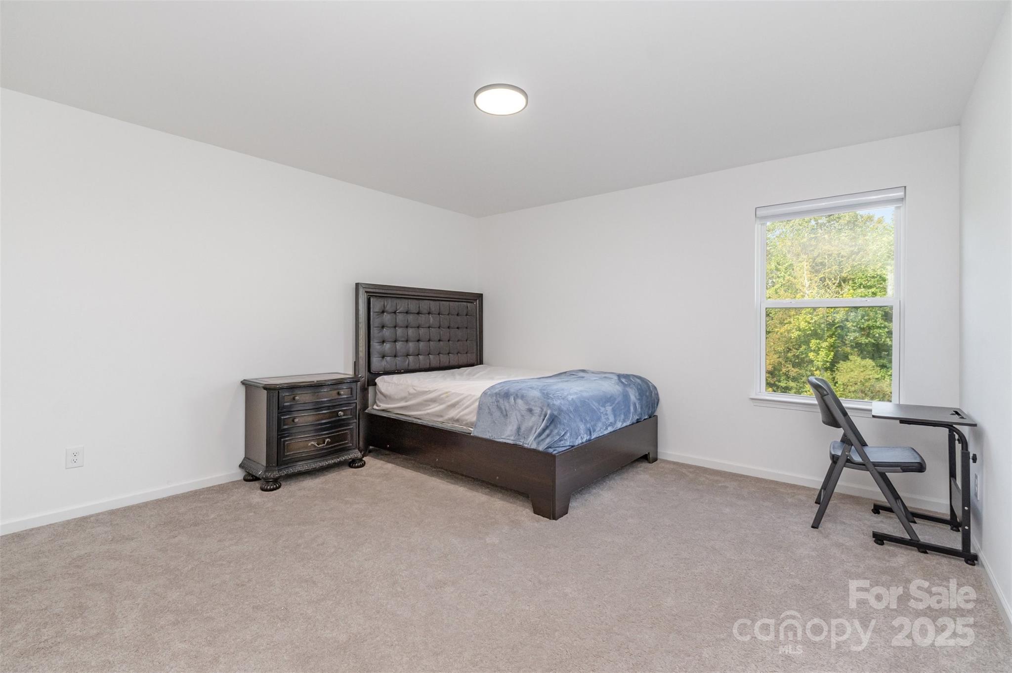 3127 Pinehills Wy. Mount Holly, NC 28120 - Photo 25 of 35 a bedroom with a bed and a chair