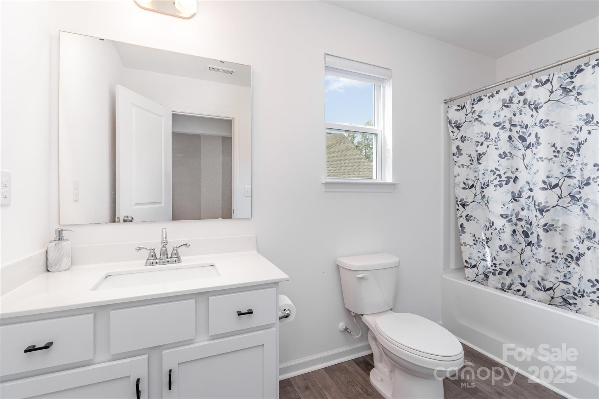 3127 Pinehills Wy. Mount Holly, NC 28120 - Photo 28 of 35 a bathroom with a sink toilet vanity and shower