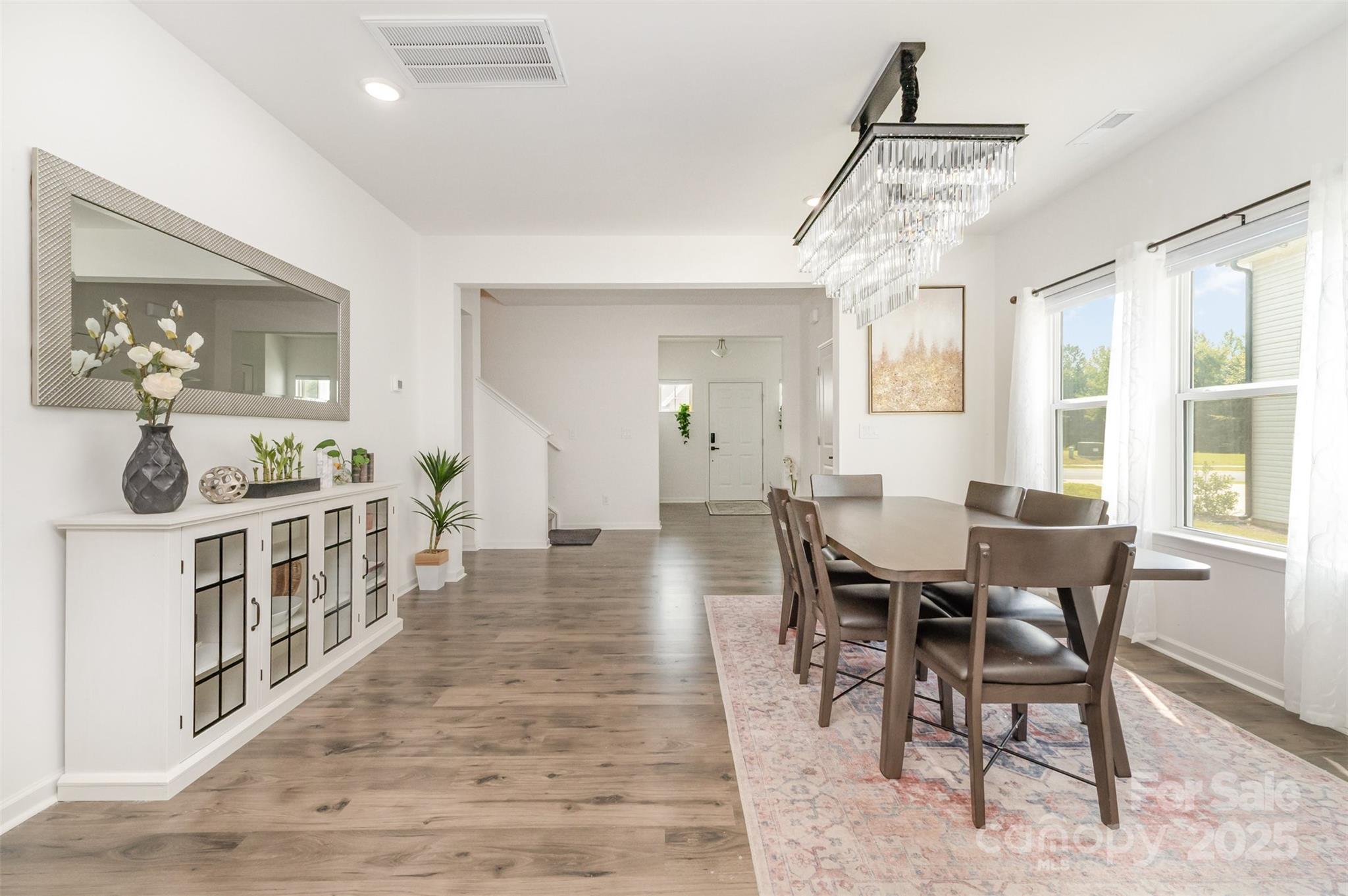 3127 Pinehills Wy. Mount Holly, NC 28120 - Photo 5 of 35 a dining room with furniture a chandelier and wooden floor