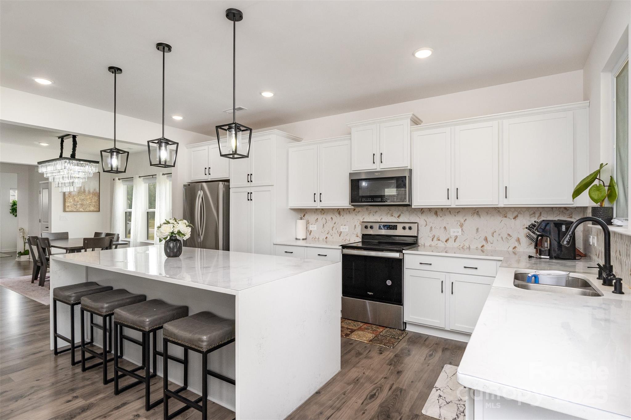 3127 Pinehills Wy. Mount Holly, NC 28120 - Photo 8 of 35 a large kitchen with kitchen island a large island in the center