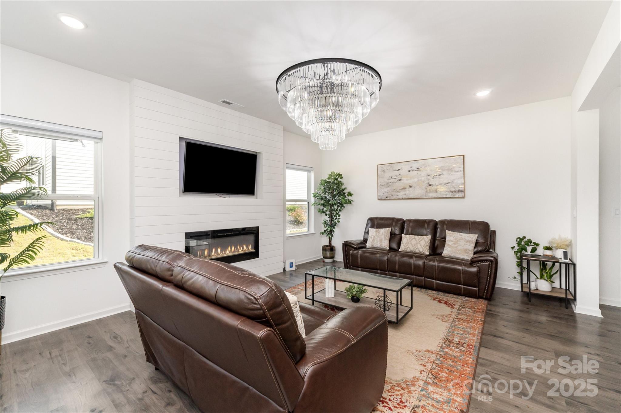 3127 Pinehills Wy. Mount Holly, NC 28120 - Photo 10 of 35 a living room with furniture a fireplace and a flat screen tv