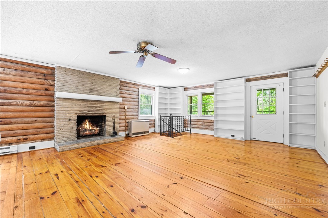 233 Alpine Acres Road Vilas, NC 28692 - Photo 1 of 32 a view of empty room with fireplace and windows