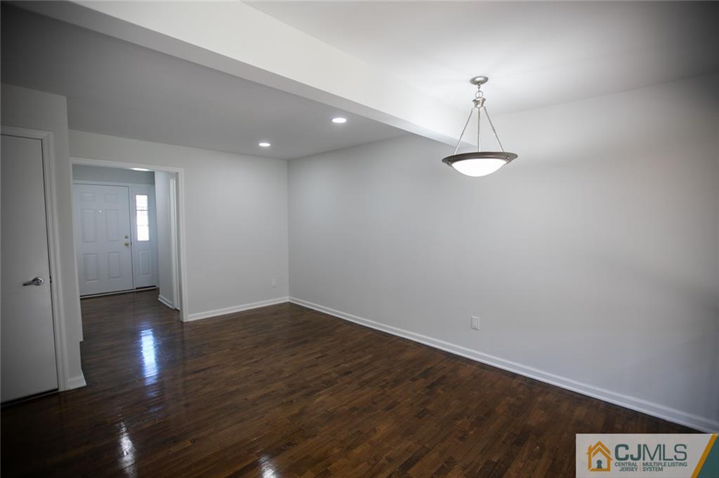 3405 Hana Road Edison, NJ 08817 - Photo 11 of 69 a view of an empty room with wooden floor and a window