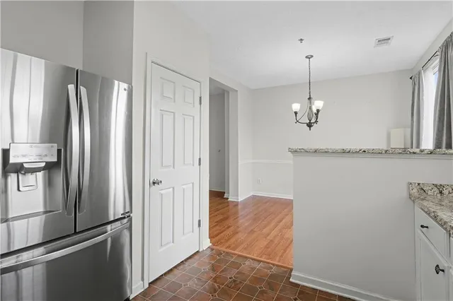a bedroom with a bed lamp and a large window