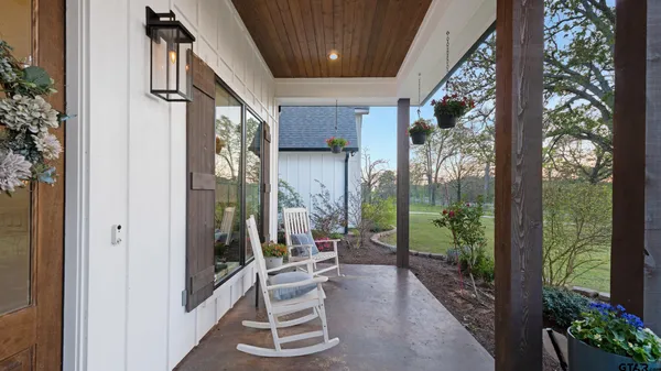 a view of outdoor dining space with plants and wooden floor