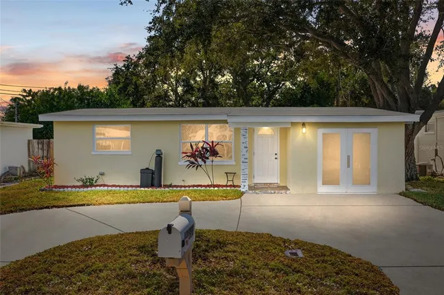 a view of swimming pool with lawn chairs under an umbrella