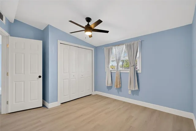 a view of an empty room and wooden floor