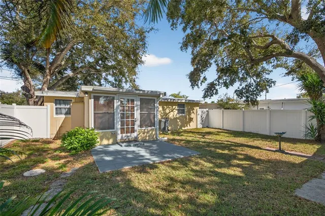 a backyard of a house with table and chairs