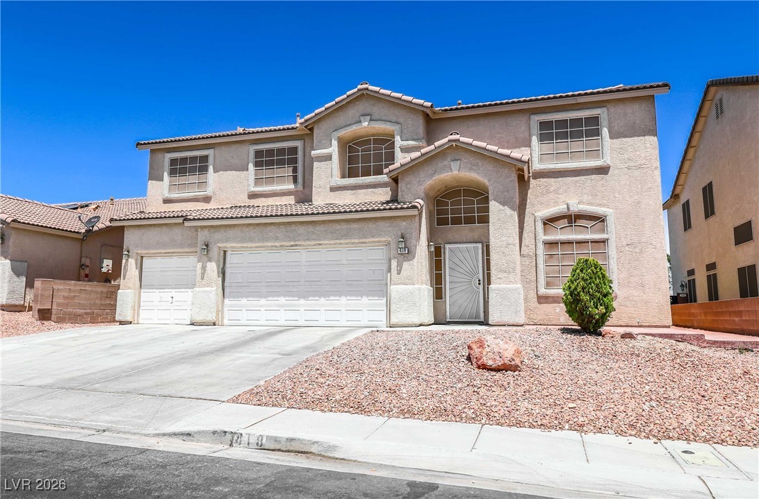 Mediterranean / spanish-style home featuring concrete driveway, stucco siding, an attached garage, and a tile roof