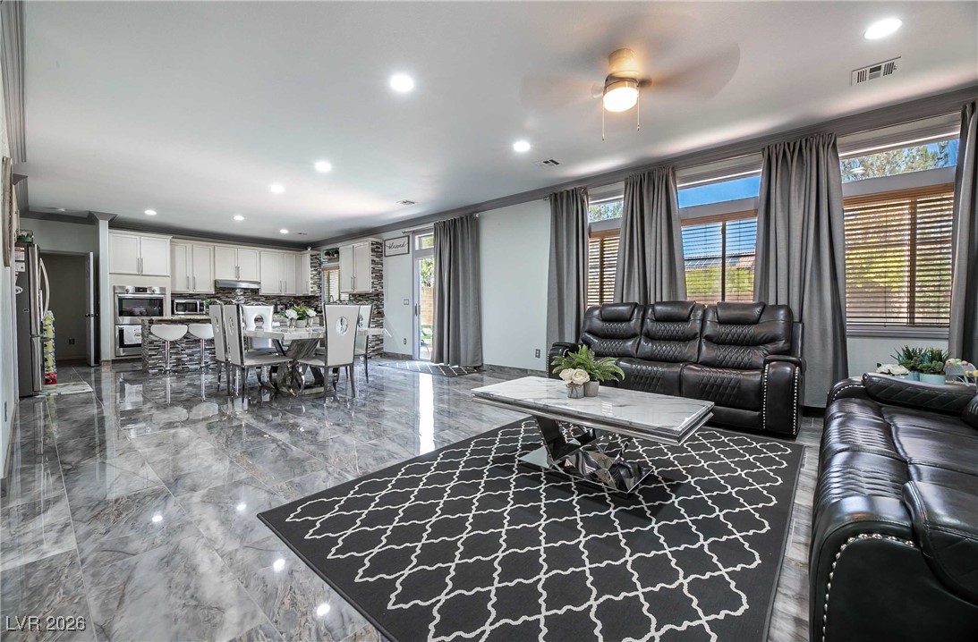 418 Finch Ridge Avenue North Las Vegas, NV 89032 - Photo 11 of 38 Living area featuring recessed lighting, healthy amount of natural light, dark marble finish floors, and ceiling fan
