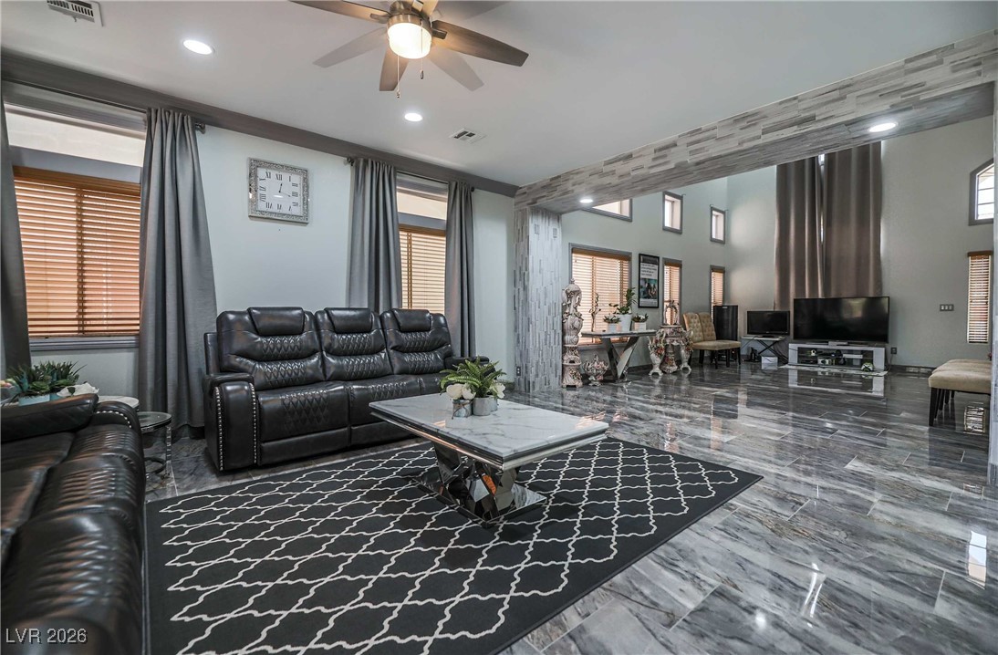418 Finch Ridge Avenue North Las Vegas, NV 89032 - Photo 12 of 38 Living room featuring ceiling fan, marble tiled floors, and recessed lighting