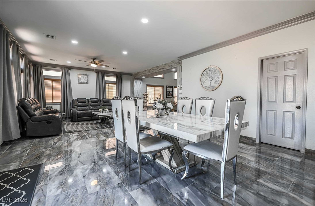 418 Finch Ridge Avenue North Las Vegas, NV 89032 - Photo 14 of 38 Dining room with ornamental molding, ceiling fan, recessed lighting, and dark marble finish floors