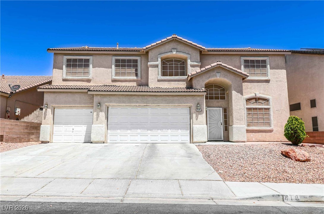 418 Finch Ridge Avenue North Las Vegas, NV 89032 - Photo 2 of 38 Mediterranean / spanish-style home featuring a garage, stucco siding, driveway, and a tiled roof