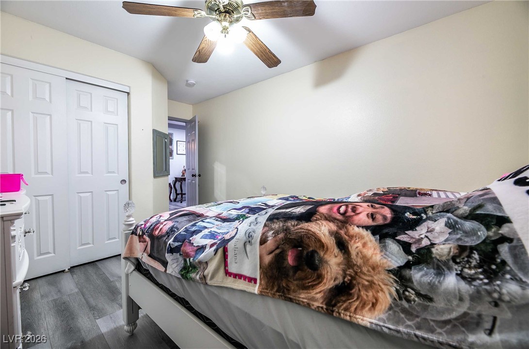 418 Finch Ridge Avenue North Las Vegas, NV 89032 - Photo 26 of 38 Bedroom with dark wood finished floors, ceiling fan, and a closet
