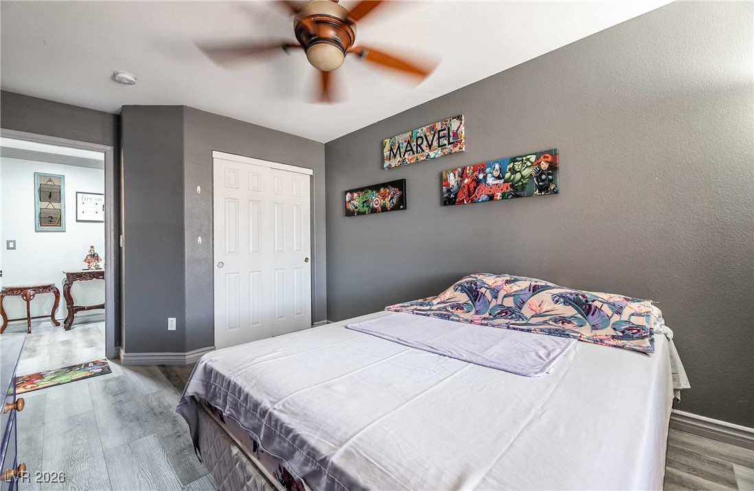 418 Finch Ridge Avenue North Las Vegas, NV 89032 - Photo 28 of 43 Bedroom with light wood-style flooring, a ceiling fan, and a closet