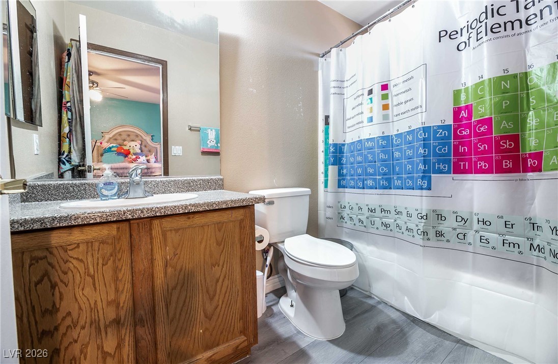 418 Finch Ridge Avenue North Las Vegas, NV 89032 - Photo 30 of 38 Ensuite bathroom with vanity, dark wood-style flooring, a ceiling fan, and a textured wall