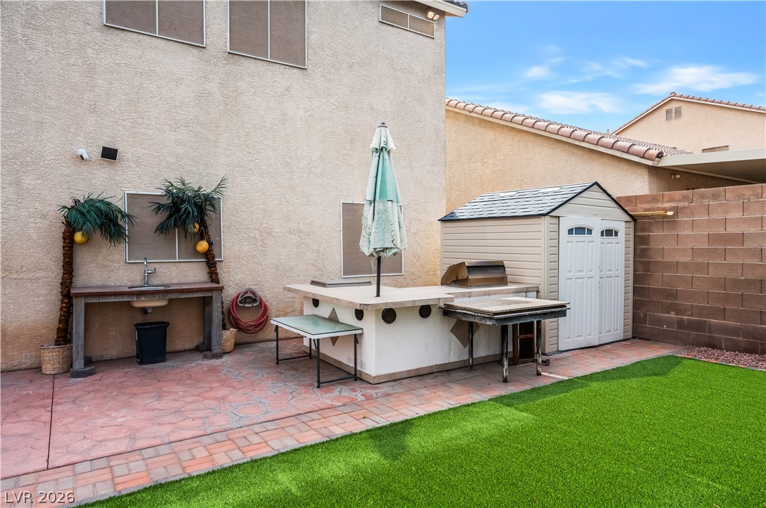 418 Finch Ridge Avenue North Las Vegas, NV 89032 - Photo 39 of 43 View of patio with a storage unit and a sink