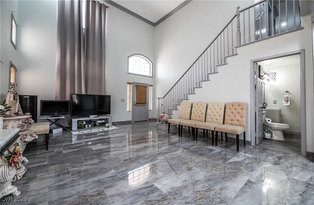 418 Finch Ridge Avenue North Las Vegas, NV 89032 - Photo 6 of 38 Foyer with a towering ceiling, marble tiled floors, stairway, and ornamental molding