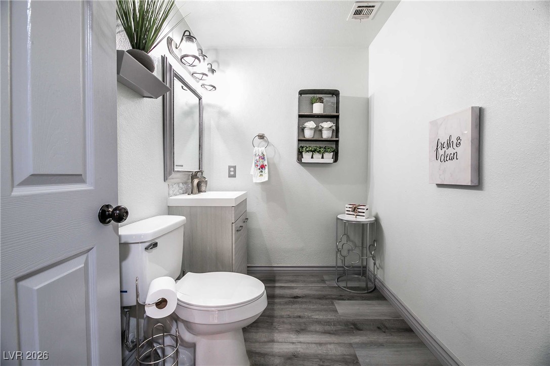 418 Finch Ridge Avenue North Las Vegas, NV 89032 - Photo 8 of 38 Bathroom featuring vanity, dark wood-style floors, and a textured wall