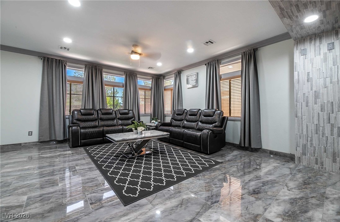 418 Finch Ridge Avenue North Las Vegas, NV 89032 - Photo 10 of 38 Living area featuring ornamental molding, plenty of natural light, a ceiling fan, marble tiled flooring, and recessed lighting