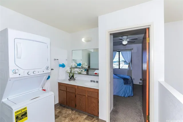 a en suite bathroom with a granite countertop sink and a mirror
