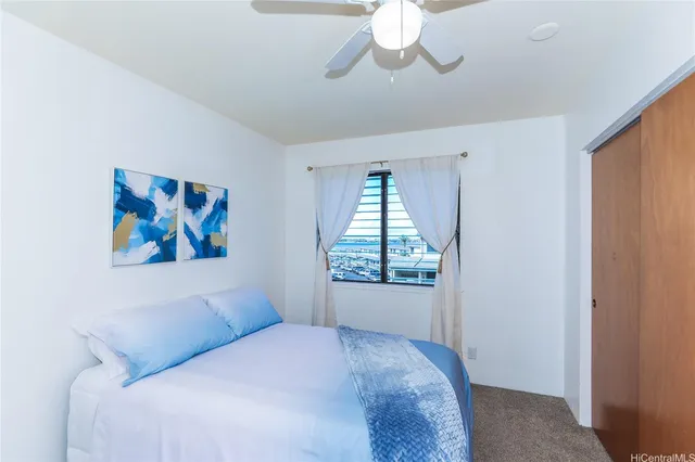 a bedroom with a bed and a painting on the wall