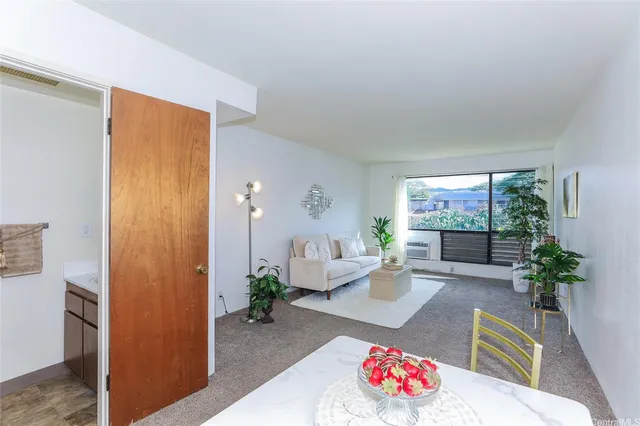 a living room with furniture and a potted plant