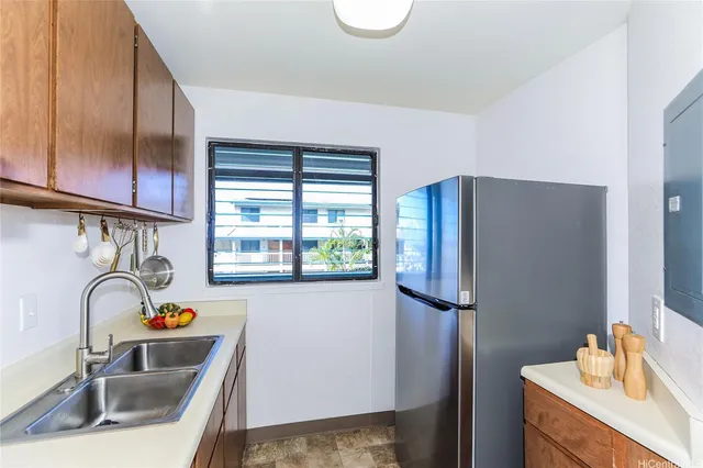 a kitchen with stainless steel appliances granite countertop a refrigerator and a sink