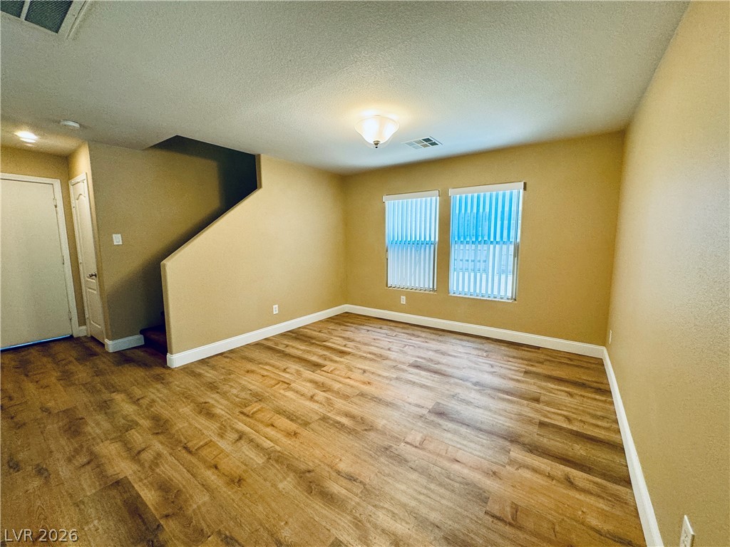 8617 Palomino Ranch Street Las Vegas, NV 89131 - Photo 6 of 27 A versatile living area with warm flooring and ample natural light awaits your personal touch.