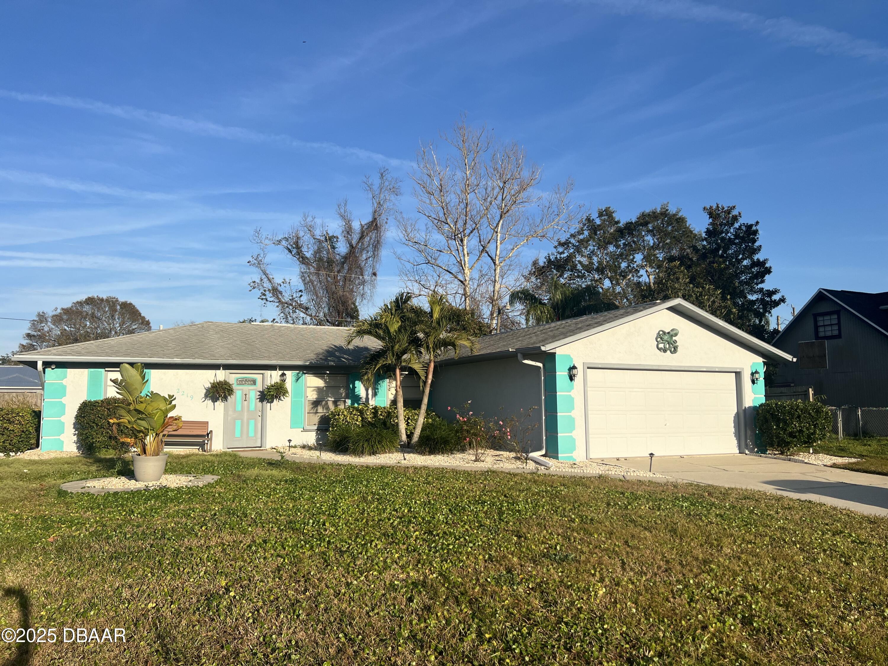 2219 Umbrella Tree Drive Edgewater, FL 32141 - Photo 1 of 22 a front view of a house with garden