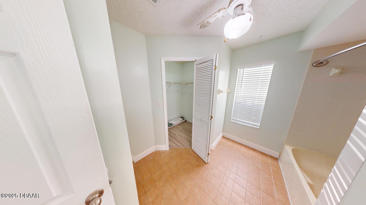 2219 Umbrella Tree Drive Edgewater, FL 32141 - Photo 11 of 22 a bedroom with a bed and a window