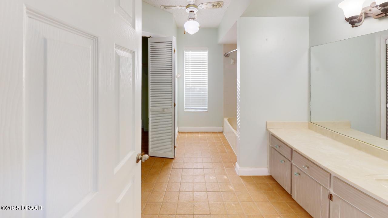 2219 Umbrella Tree Drive Edgewater, FL 32141 - Photo 12 of 22 a bathroom with a sink and a mirror
